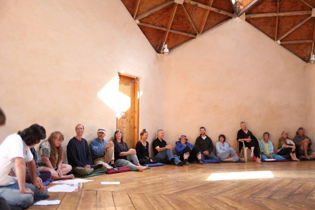 group of people sitting in a circle - Lama annual meeting