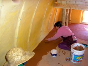 woman finishing a natural earth floor